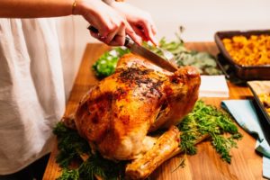 woman carving a roasted turkey